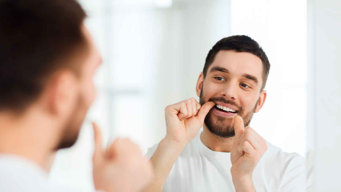 A man flossing his teeth