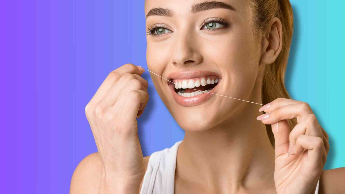 A woman flossing her teeth