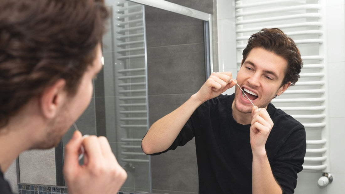 A man flossing his teeth