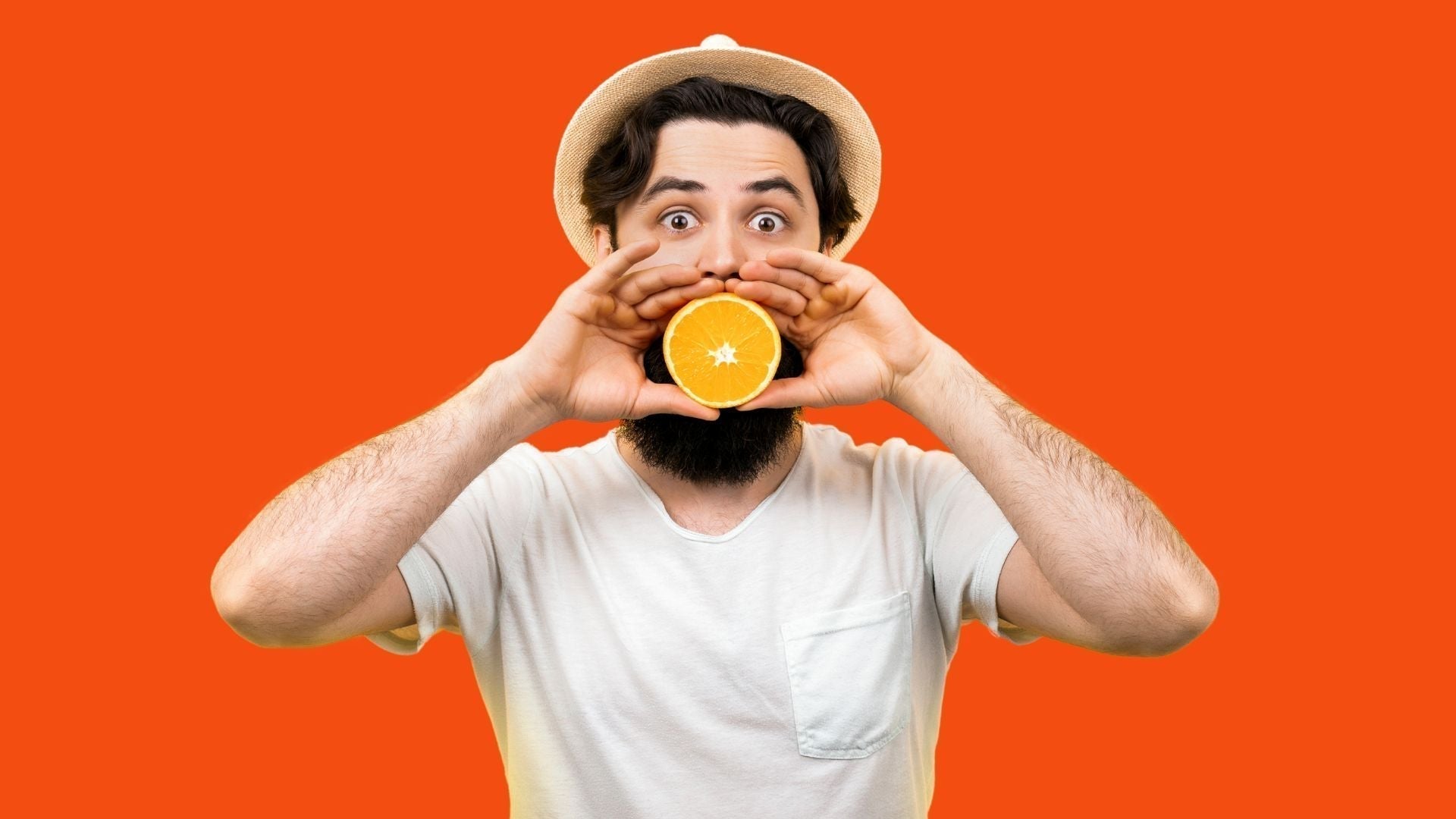 a man holding orange