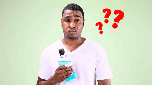 A man holding alcohol mouthwash