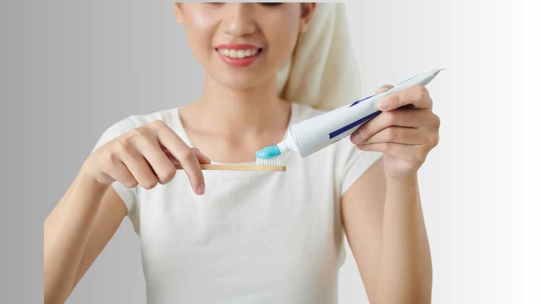 A woman using whitening toothpaste